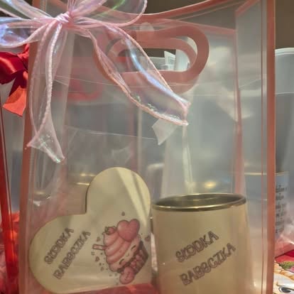 Gift set with heart-shaped mug and cylindrical mug tied with pink ribbon bow in decorative packaging