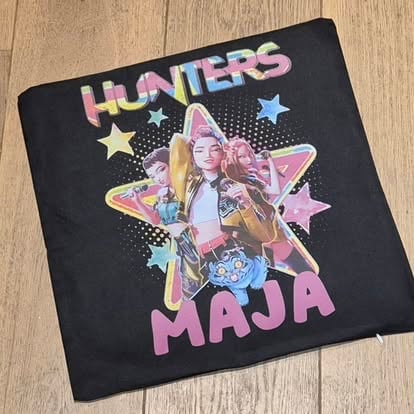 Black t-shirt with Hunters Maja text and graphic of a woman posing with colorful stars on wooden floor