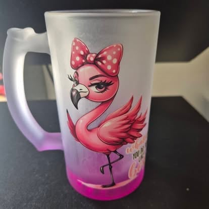 Frosted glass mug featuring a pink flamingo character with a polka dot bow and thin leg design