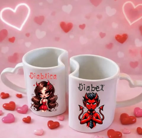 Two white heart-shaped mugs labeled diabetica and diabex with cartoon characters on a pink background with decorative hearts